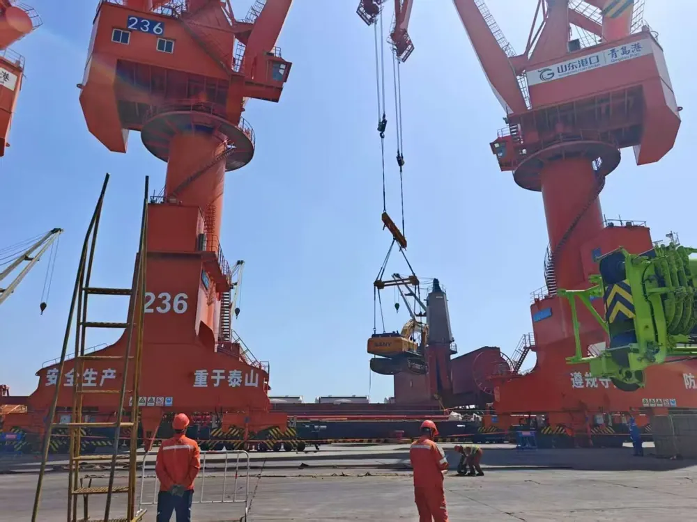 Gantry cranes loading a used excavator for export at a Chinese port